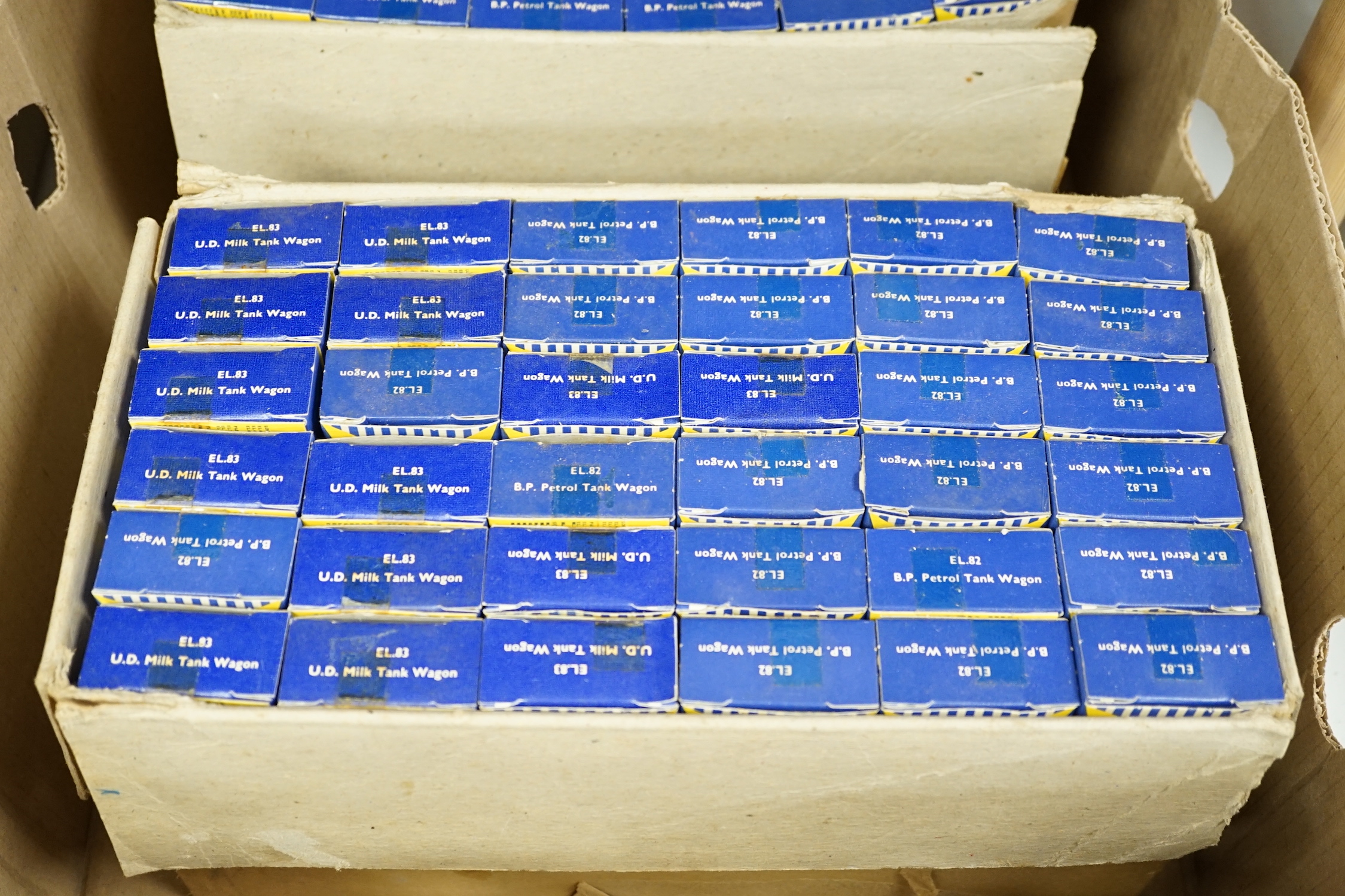 A collection of boxed Lone Star 000 gauge model railway, contained within two original trade boxes with most items, appearing boxed as new, comprising Shell Oil wagons, petrol tank wagons, milk tank wagons, etc. (144 ite